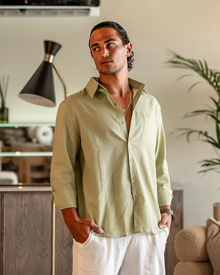  Male model styling a long sleeve casual shirt on a plain background.