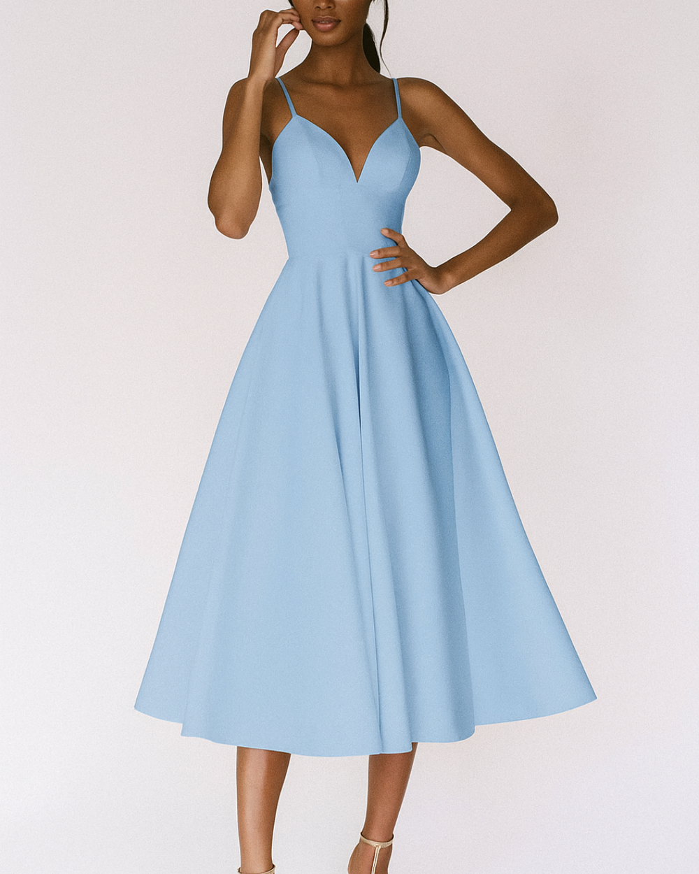 Woman in an elegant strappy midi dress styled on a plain background.