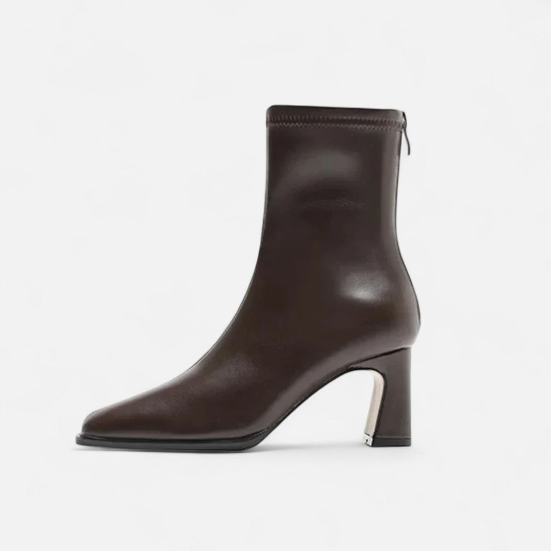 Ankle-height boots with a polished finish on a plain background.