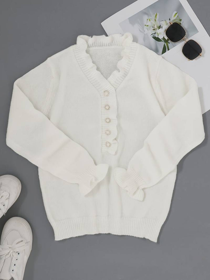 Feminine ruffle blouse shown against a plain background with soft neckline accents, front view