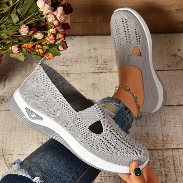 Women’s walking knitted shoes angled display on wooden background