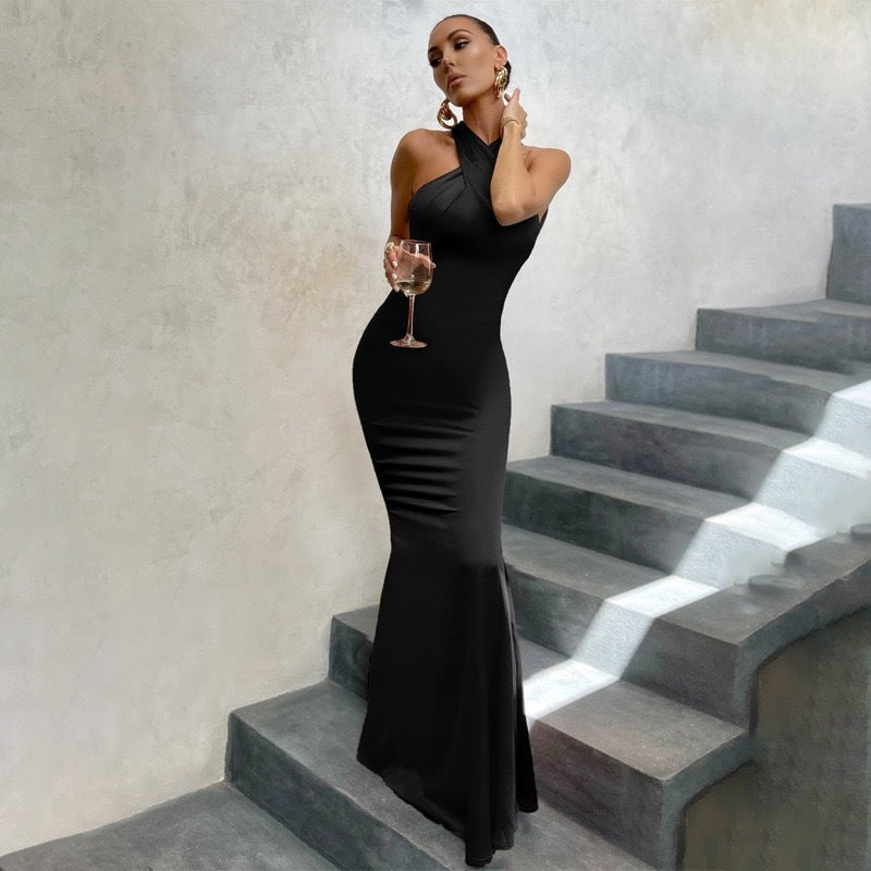 Woman wearing a formal dress against a plain background.