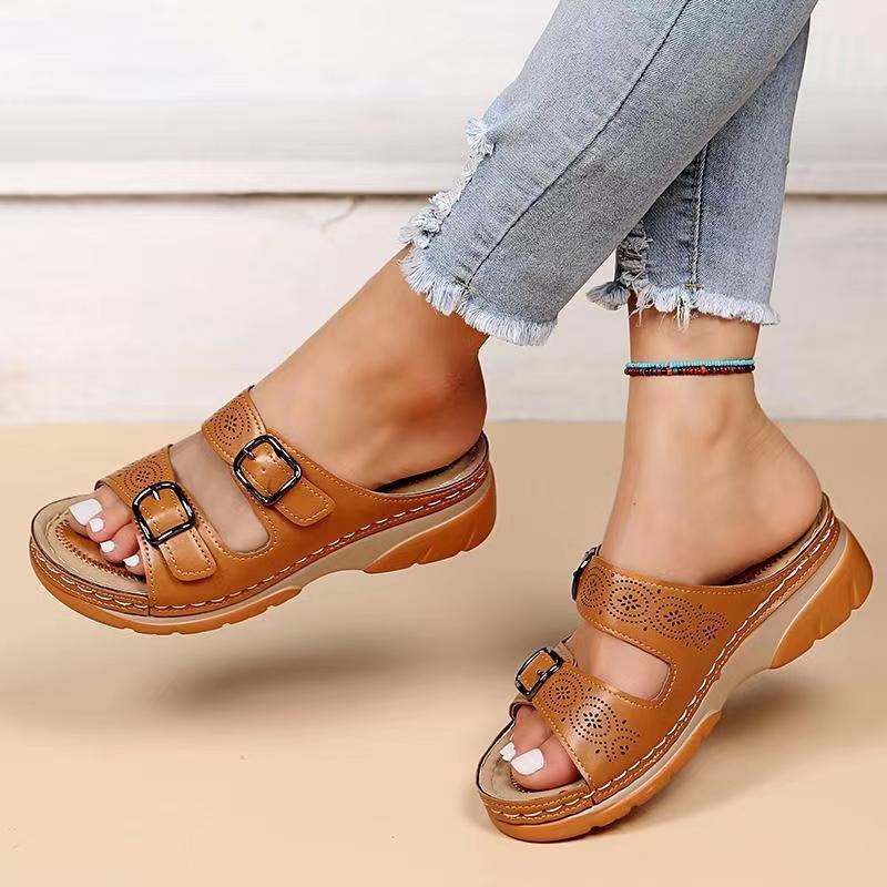 Top view sandals worn by foot model plain beige backdrop
