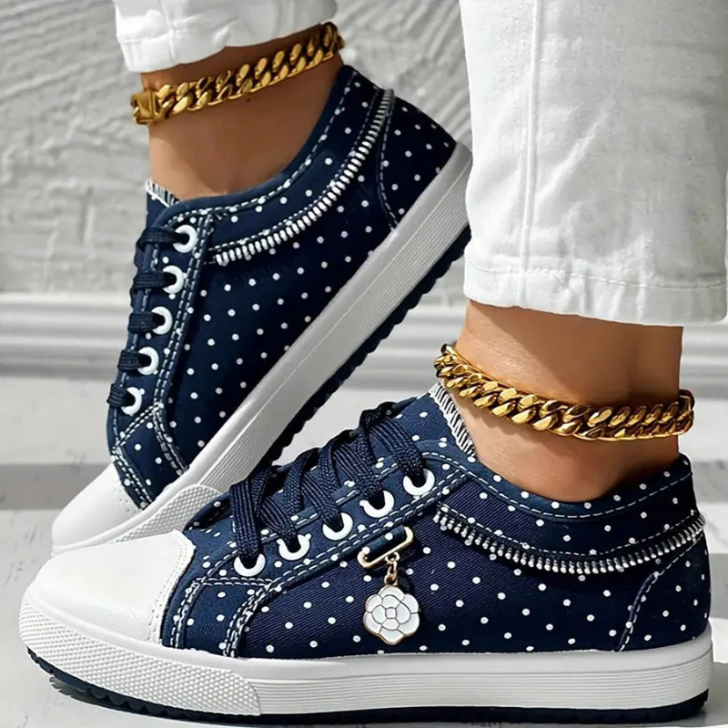 Side angled dotted navy blue shoes with textured white soles