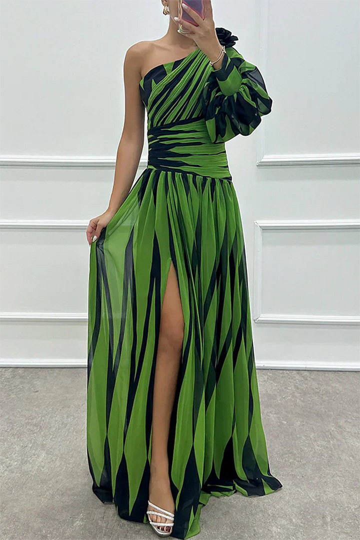 Female model in a striped one-shoulder dress with a flowing skirt on a plain background.