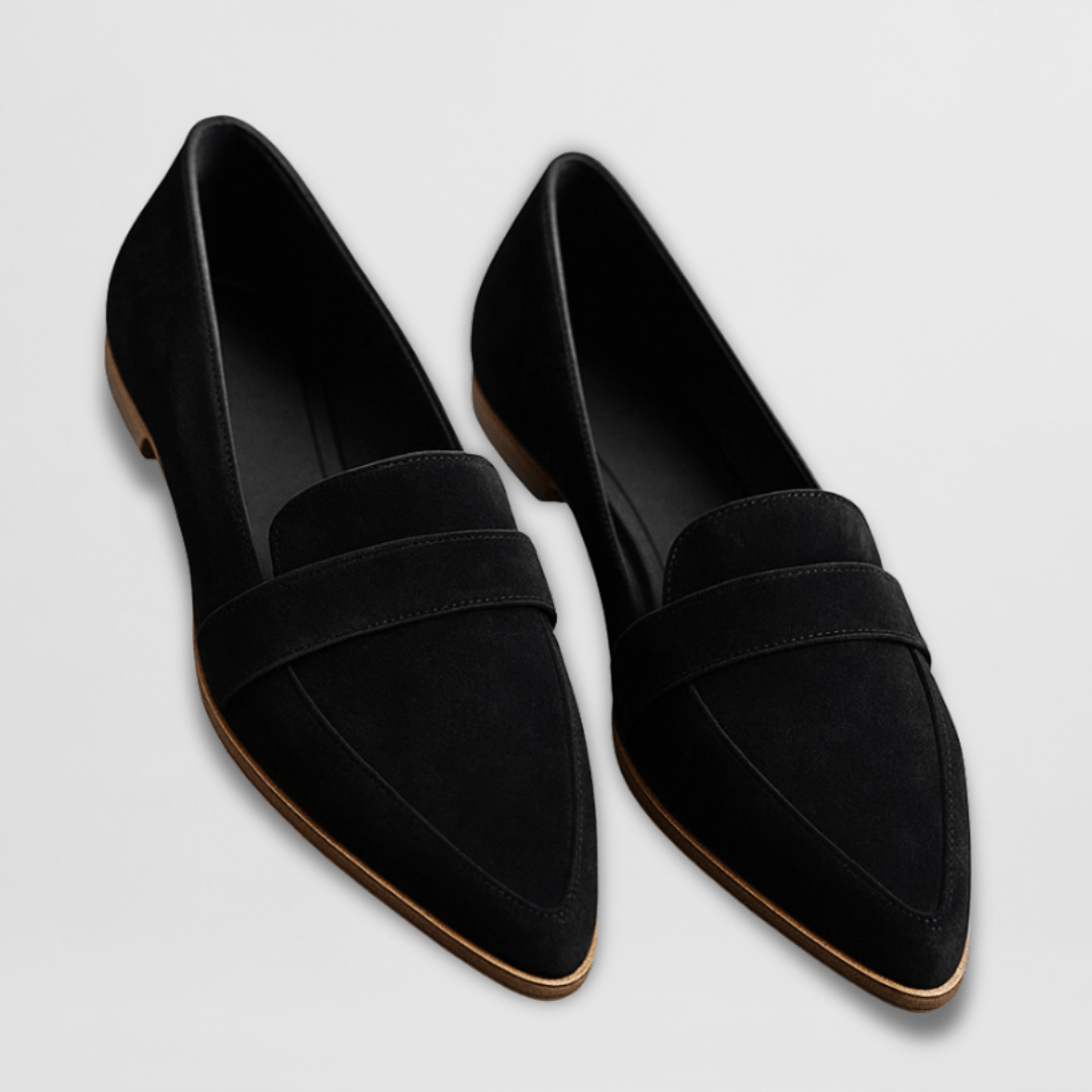 Casual loafers with a simple outfit on a plain background.