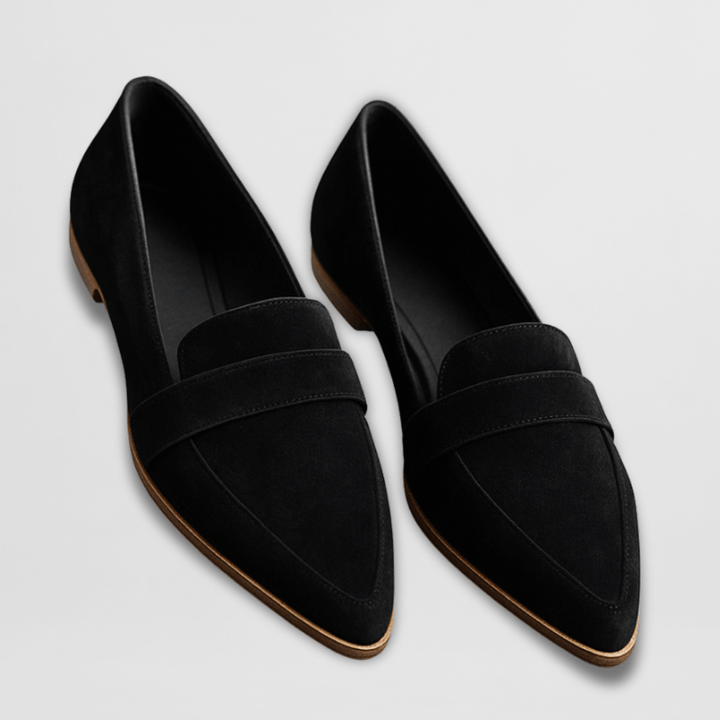 Casual loafers with a simple outfit on a plain background.