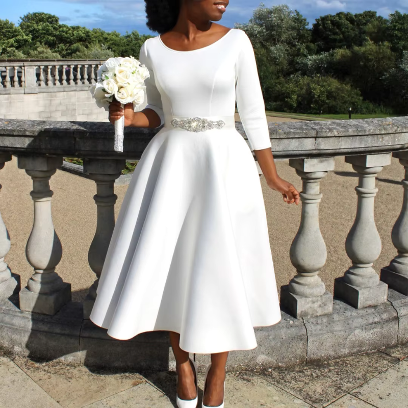 Woman wearing elegant midi dress posing on multi-color terrace background backdrop.