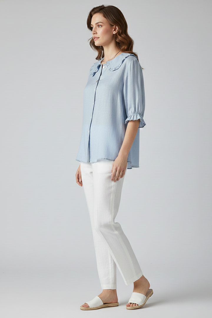 Elegant lady wearing top with frilled neck detail with ruffle sleeves