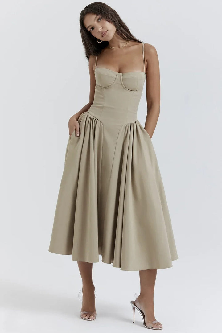 Female model showcasing a feminine midi dress on a plain background
