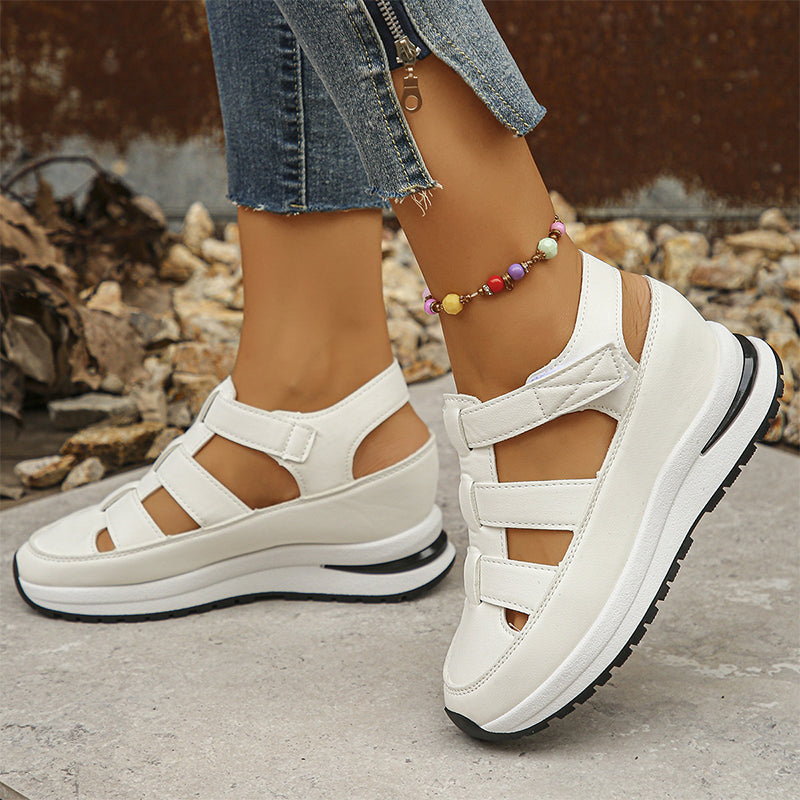 White casual wedge shoes photographed outdoors on feet
