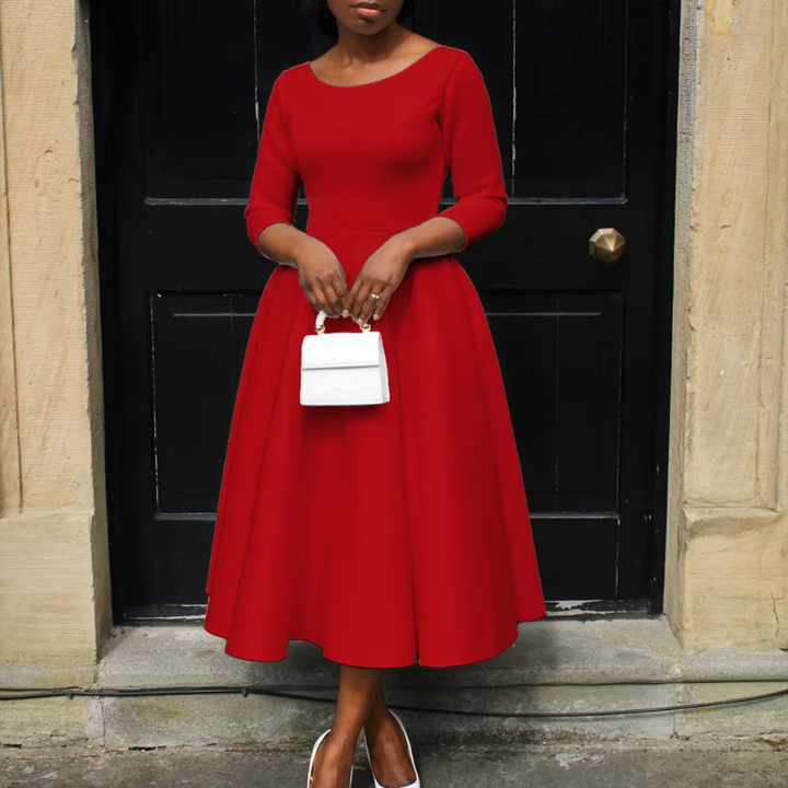 Woman in sophisticated event dress posing with confident formal style.