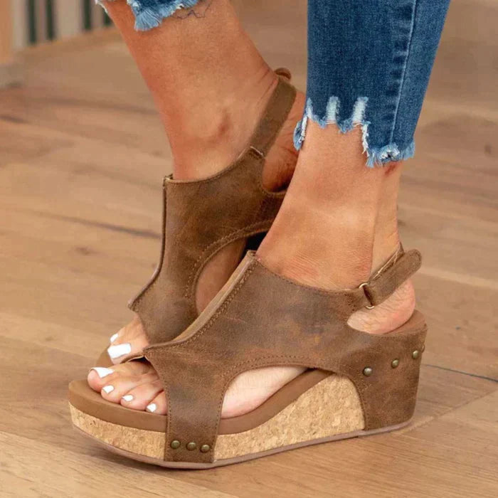 Foot model wearing wedge sandals side view plain background studio