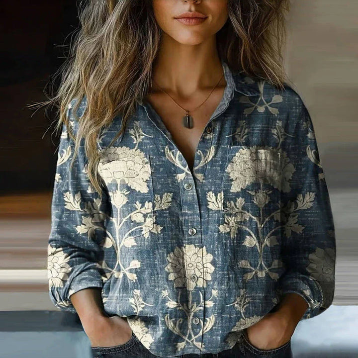 Woman model showcasing a printed button front top with a relaxed fit on a plain background.