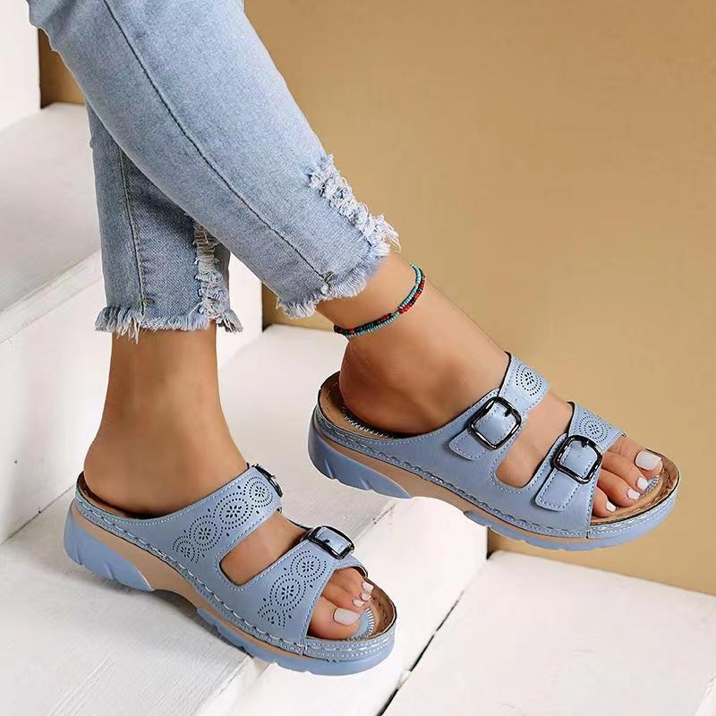 Angled side view showing sole and straps beige background