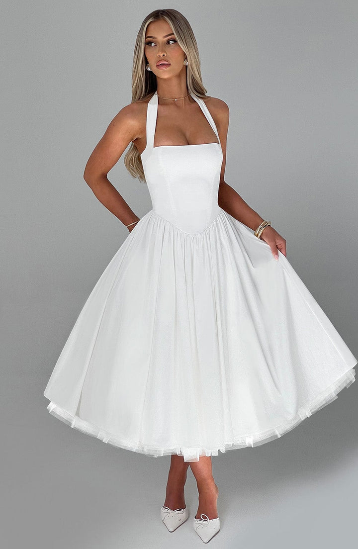 Woman posing back view in graceful midi dress, gray plain.