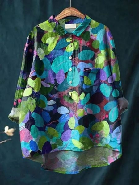 Women’s casual floral blouse with front pocket accent.