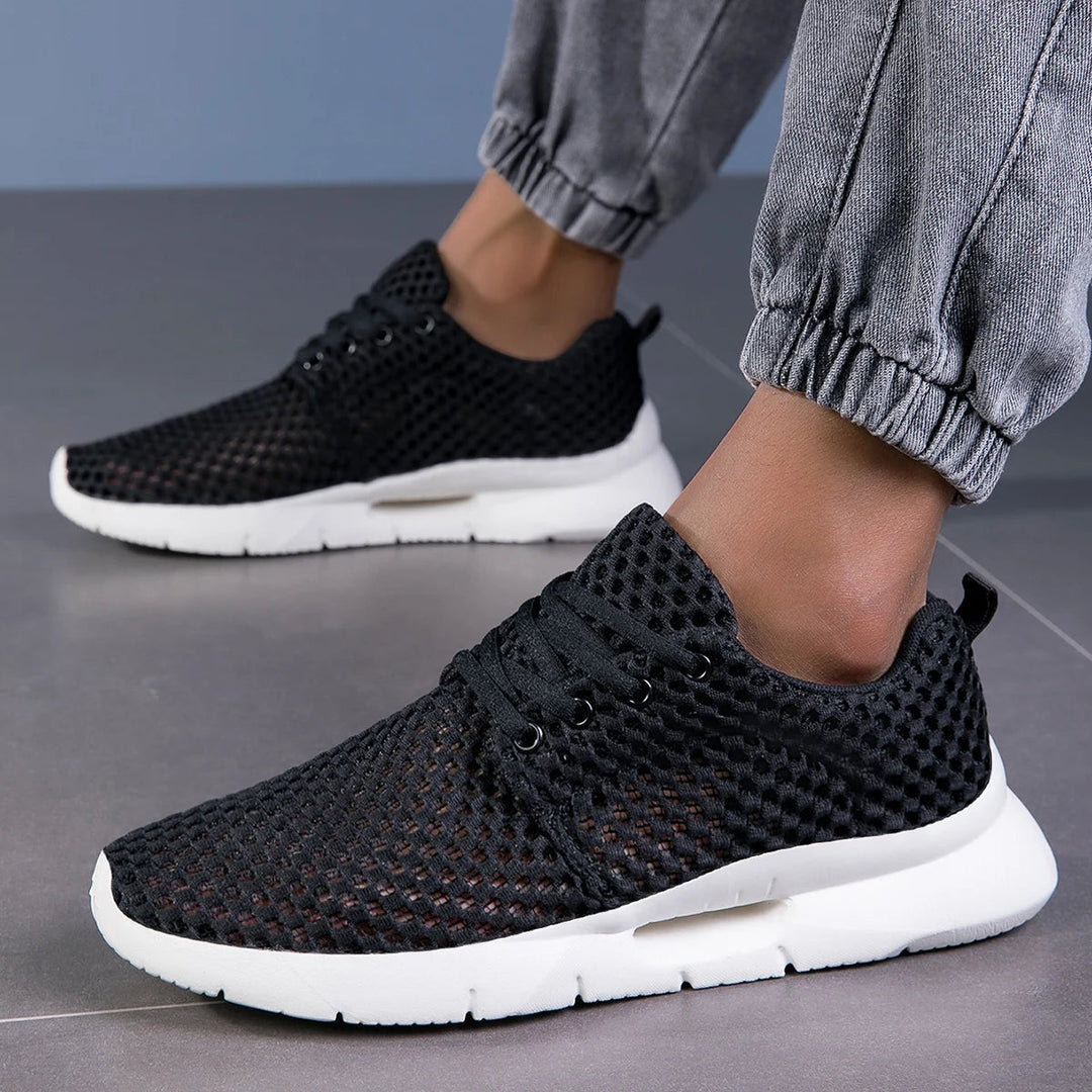 Modern black sneakers styled with denim joggers