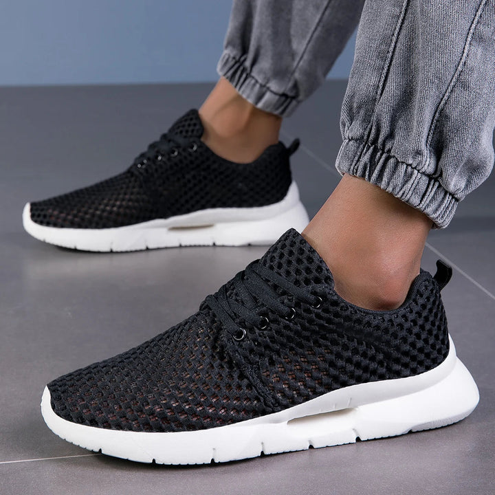 Modern black sneakers styled with denim joggers