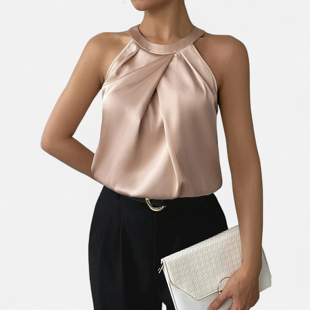 Woman model showcasing a sleeveless satin tank with elegant pleated detail on a clean background