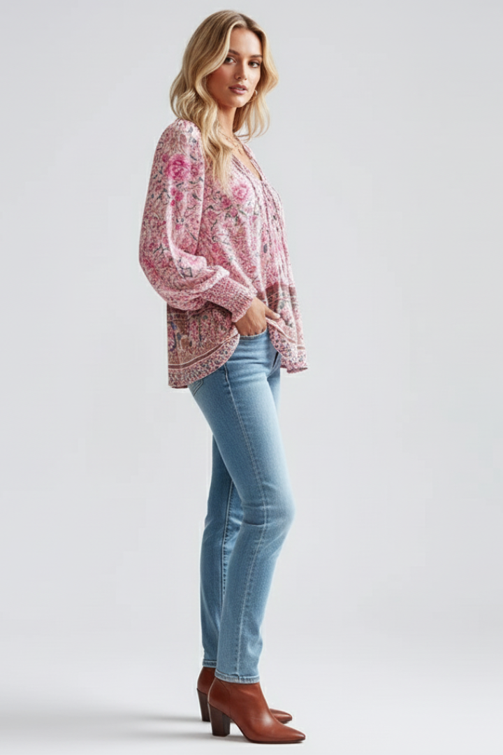 Full length side angle studio image with flowy patterned blouse