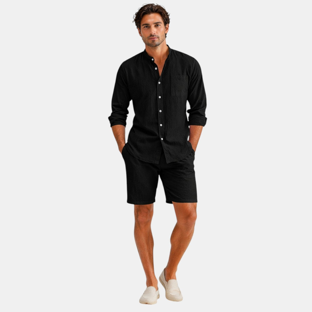  Male model showing a casual warm weather outfit with a plain background.