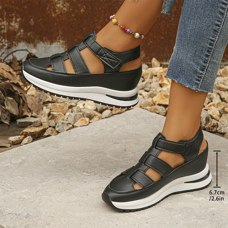 Black cutout wedge sneakers side view on model