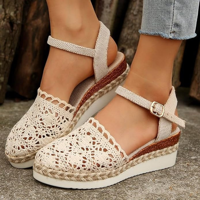 Side view of crochet espadrilles on plain background with foot