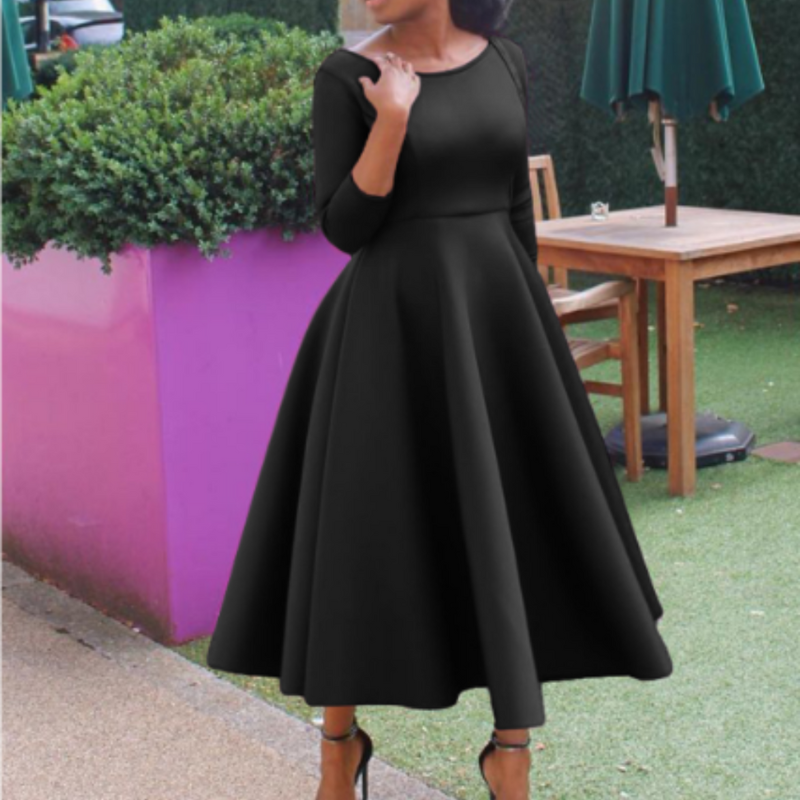 Female model in stylish occasion dress with multi-color backdrop setting.
