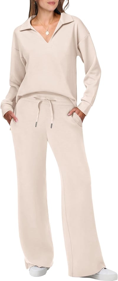 Woman in a coordinated long sleeve top and leggings on a plain background.