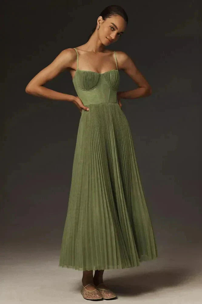 Woman model wearing an elegant pleated A-line midi dress on a plain background.