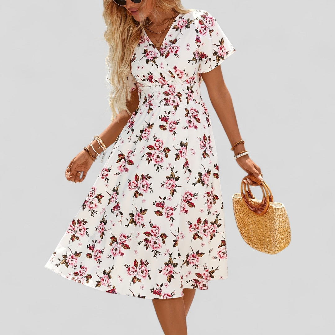 Flowy floral midi dress styled with woven handbag
