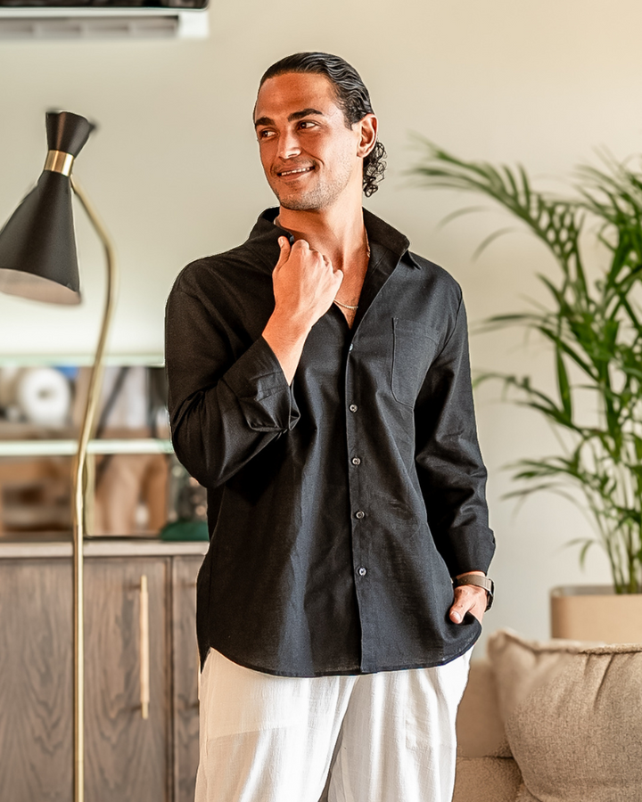 Male model in a simple collared shirt with chest pocket on a plain background.
