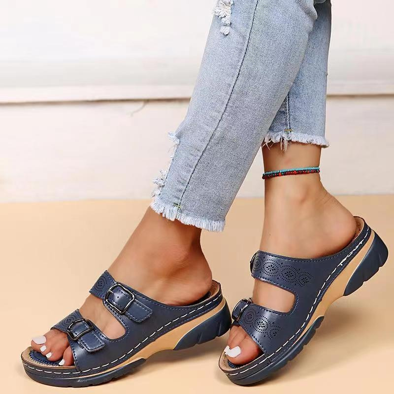 Front view of open-toe sandals on beige background foot model