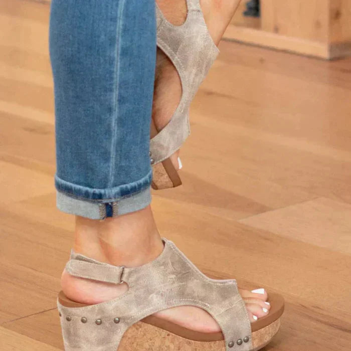 Foot model angled side view wedge sandals plain background lighting