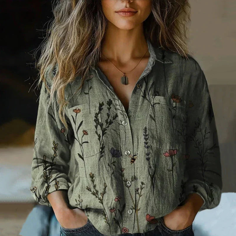 Female model in a patterned long sleeve blouse styled on a clean background.