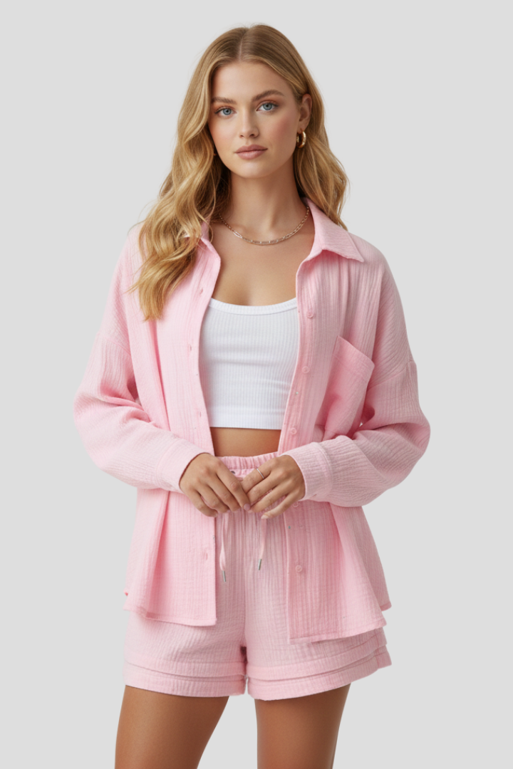 Female model wearing lightweight textured all pink outfit, front pose, gray background.