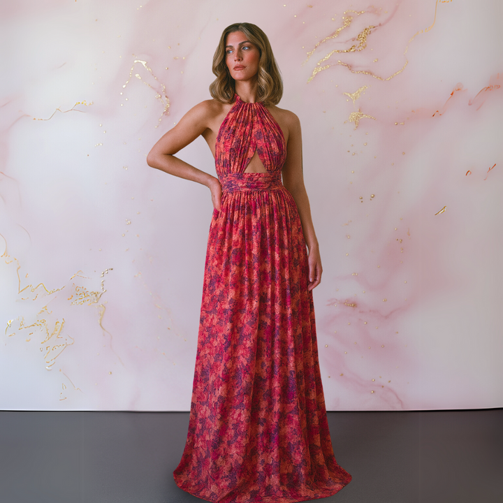 Woman wearing a sleeveless floral maxi dress with an elegant open-back look.