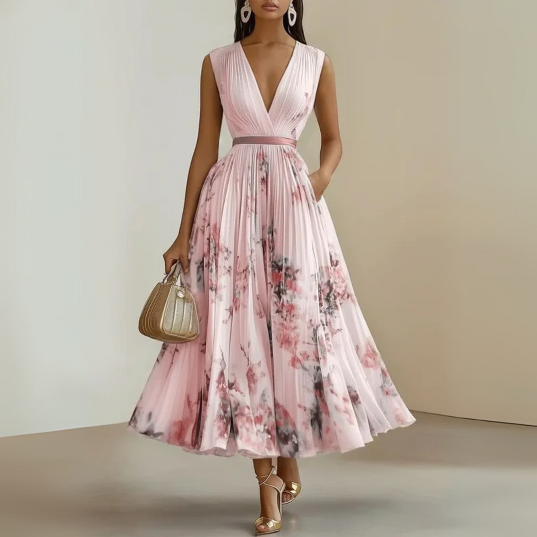 Women’s pleated outfit displayed on a plain background with soft flowing detail.
