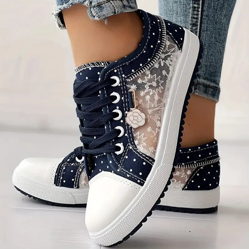 Blue lace trimmed shoes on clean white background
