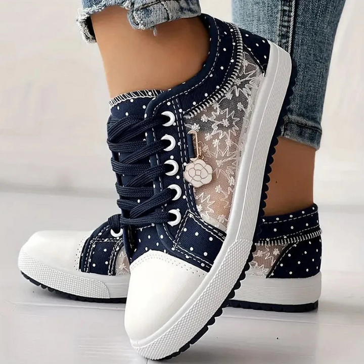 Blue lace trimmed shoes on clean white background