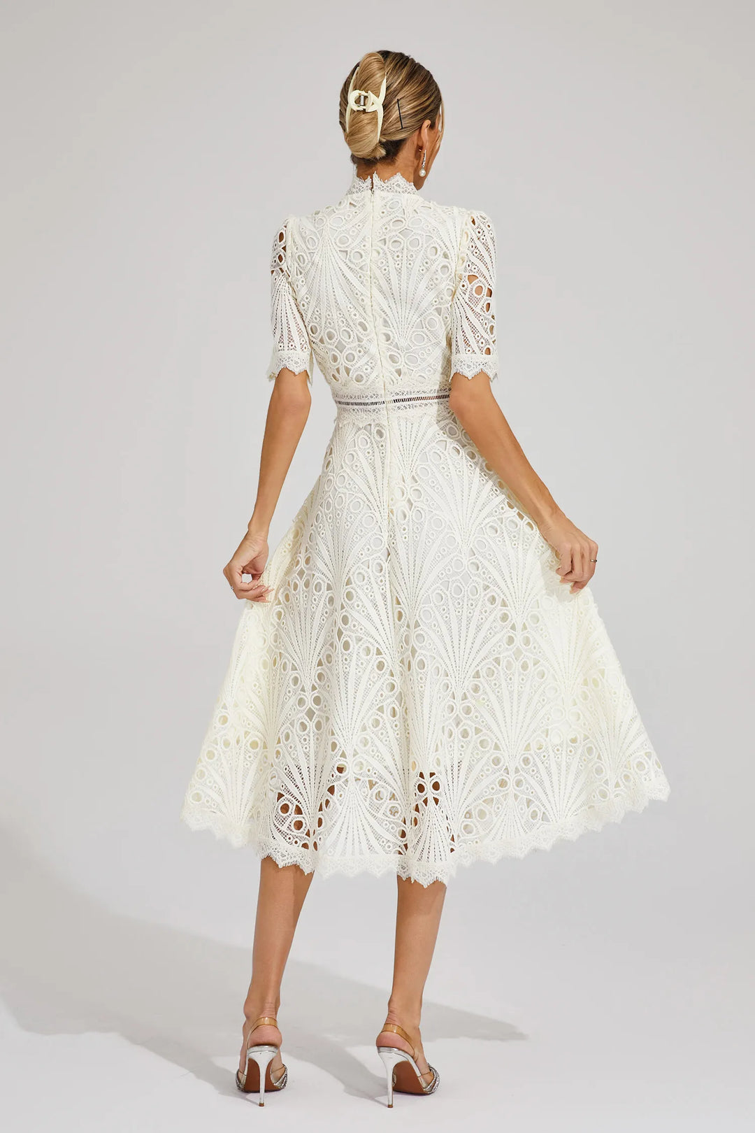 Back view, wearing a versatile lace dress suitable for weddings and parties on a plain background.