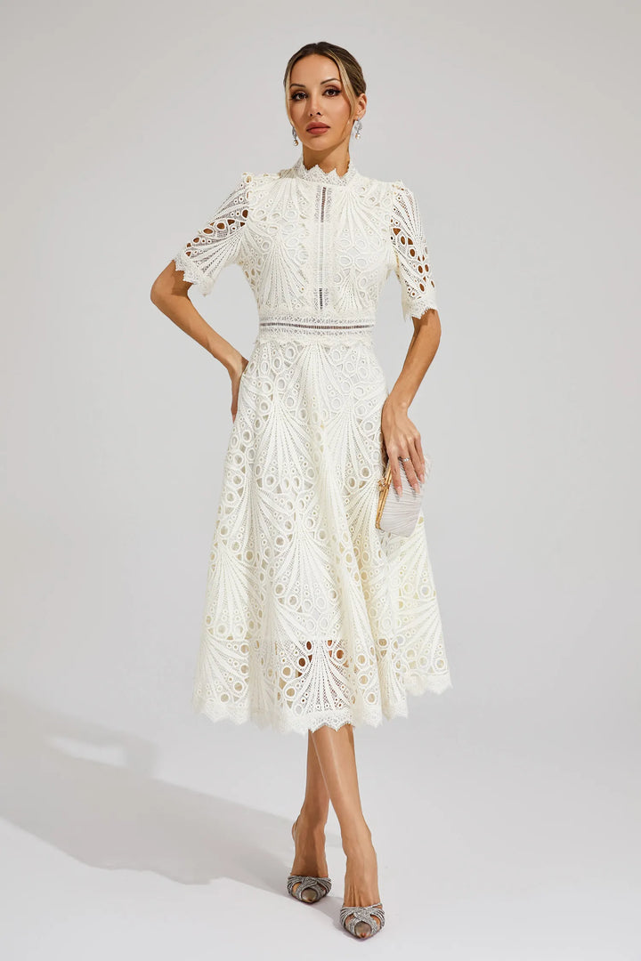 Woman model in a graceful lace A-line dress perfect for events on a plain background.