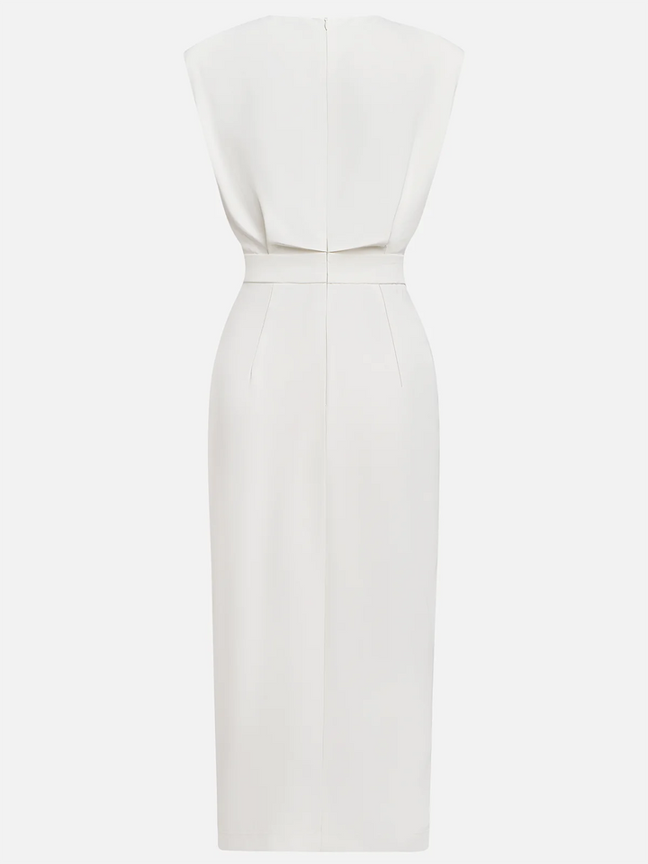 Woman in a graceful everyday dress with button slit detail on a plain background.