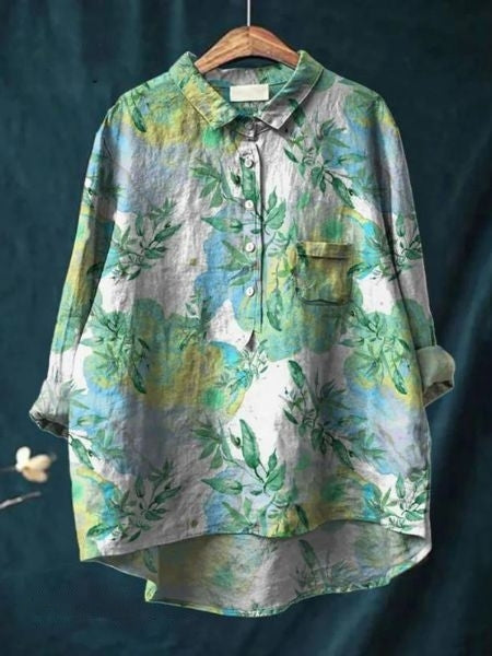 Vibrant summer blouse with colorful floral print and buttons.
