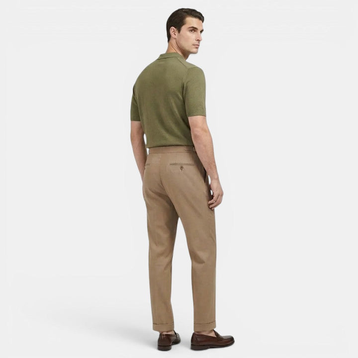 Female model standing in classic straight-fit trousers on a plain background.