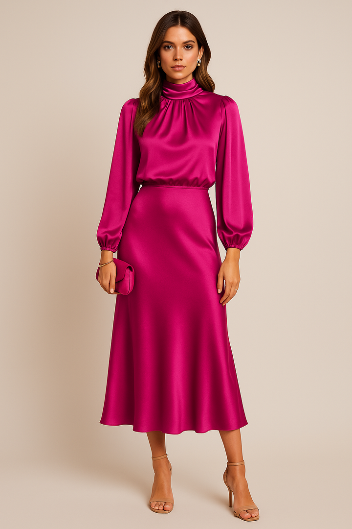 Woman wearing a pink satin dress with long sleeves on a beige background
