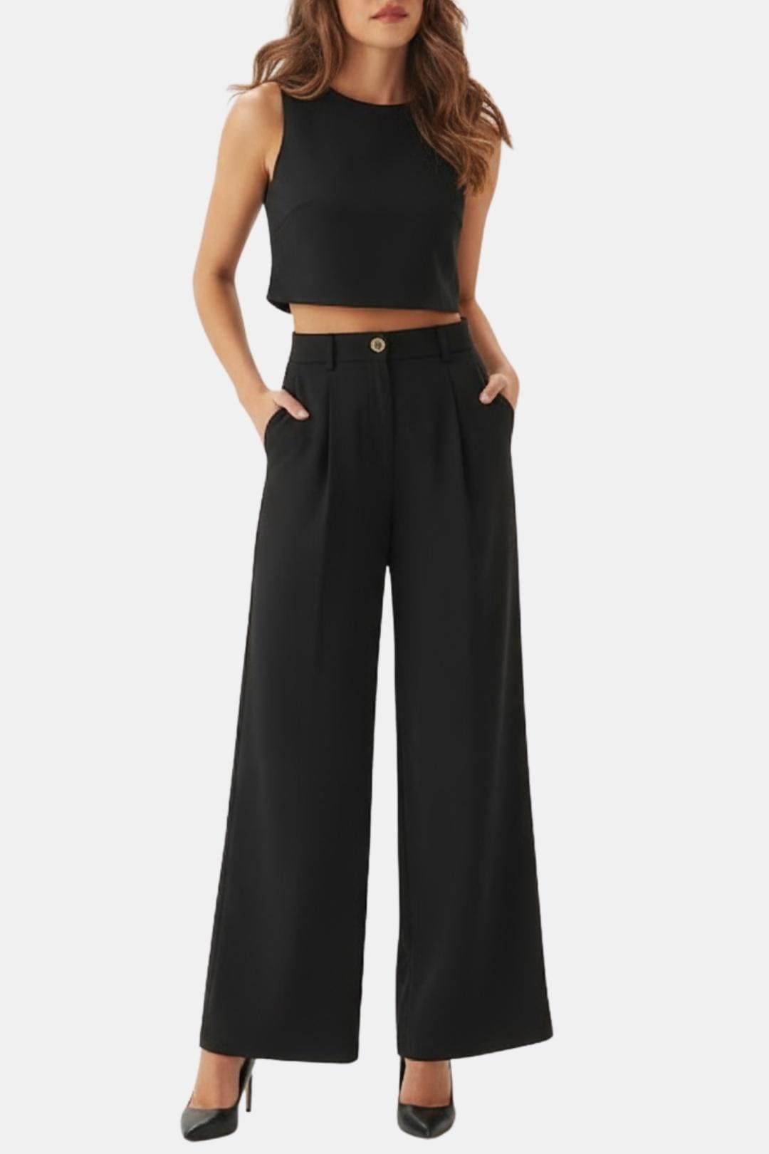 Female model wearing a sleeveless crop top with wide-leg pants on a plain background.