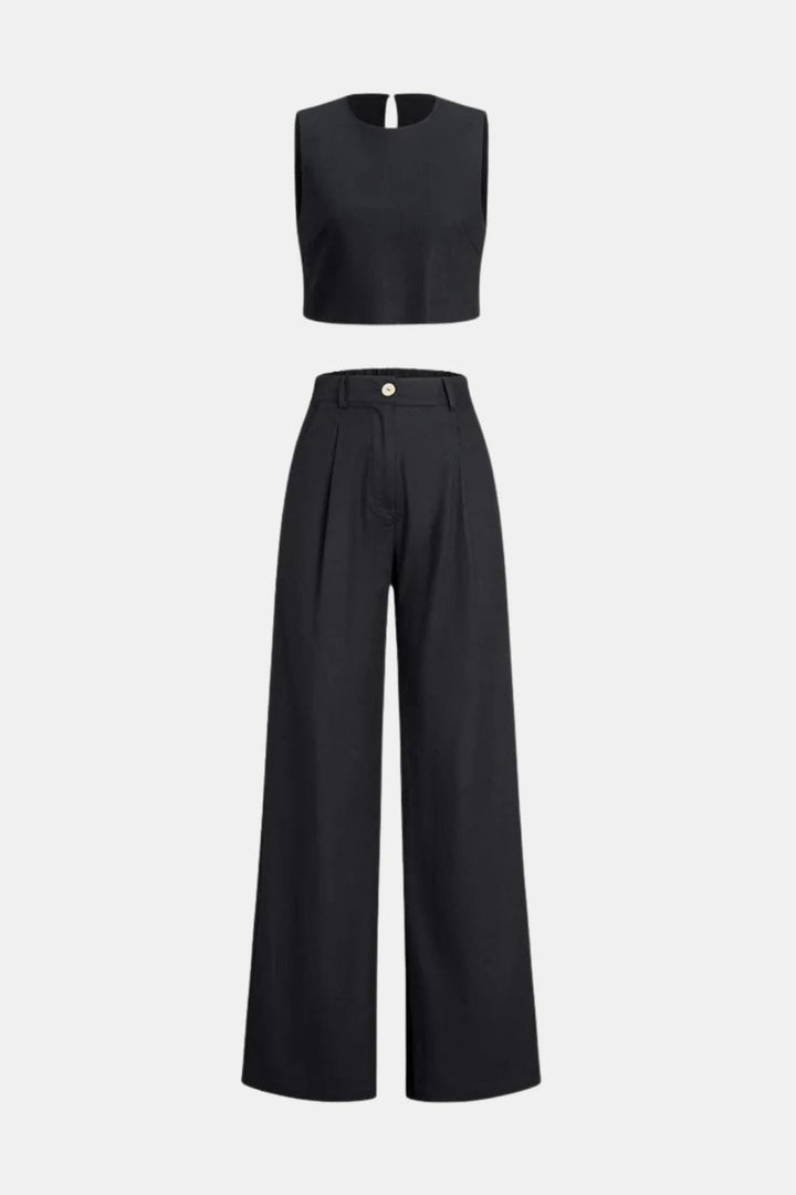 Relaxed two-piece outfit with flowy trousers against a plain background.