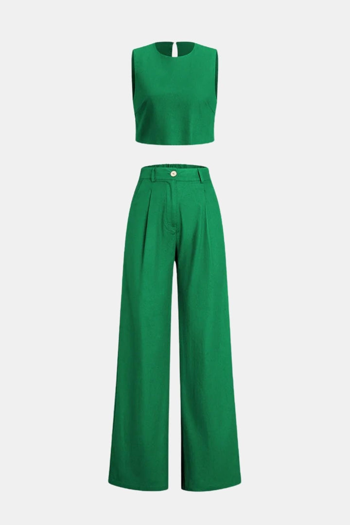 Modern cropped top and loose pants on a plain background.